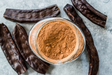 Carob Powder and Pods Ready to Use in Jar.
