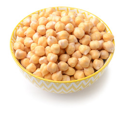 Bowl with raw chickpea on white background