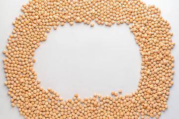 Frame made of raw chickpea on light background