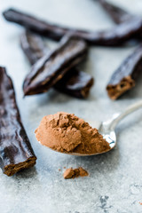 Carob Powder and Pods Ready to Use in Spoon