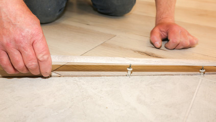Installation of threshold indoors. Renovation works in the flat.