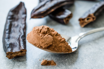 Carob Powder and Pods Ready to Use in Spoon