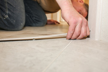 Installation of threshold indoors. Renovation works in the flat.