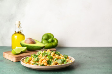 Plate with tasty tasty chickpea on table