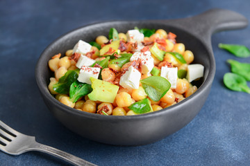 Bowl with tasty chickpea salad on table