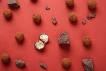Fototapeta na wymiar Tasty sweet truffles and chocolate on color background
