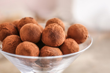 Glass with tasty sweet truffles, closeup