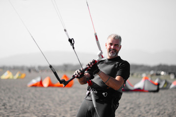 Kite surfer having fun on a beautiful sunny and windy day. Extreme sports and fun. Kitesurfing lessons. Sea and sun. Extreme watersports.
