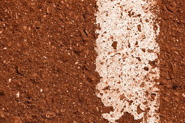 Old dirty asphalt surface with white paint on it brown color toned