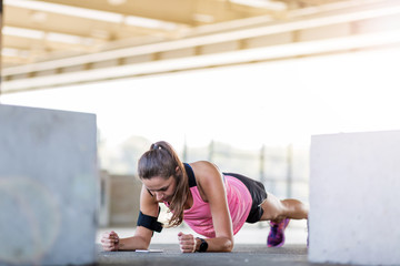 Young woman doing stretching exercise in urban area
