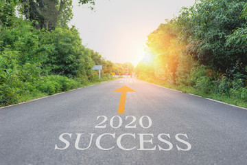The asphalt road and the blurred road are empty and mark which symbols are successful. Concept of Success 2020, Journey to the Future 2021.