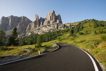 Asphalt road in Dolomites in a summer day, Italy.