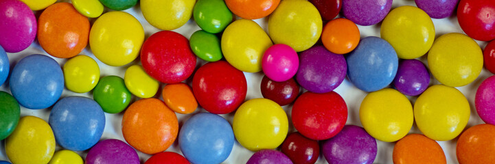 Fototapeta na wymiar Many colorful candies as panoramic background