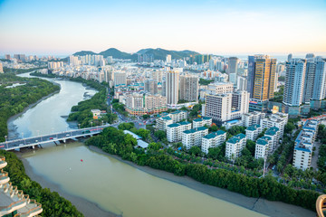 Aerial view of Sanya city with river at sunset light, Hainan province, China