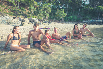 Group of friends celebrating on an island in Thailand