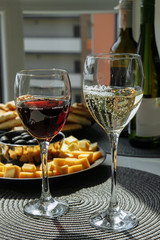 glass of red wine with food on the table