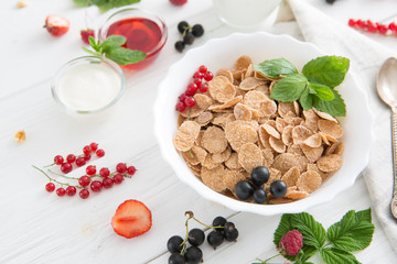 Multigrain wholewheat healthy cereals with fresh berry. Healthy tasty breakfast multigrain wholewheat healthy cereals with strawberries, raspberries, black currants and red currants.