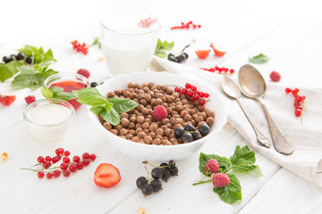 Multigrain wholewheat healthy cereals with fresh berry for breakfast overhead shot Healthy tasty breakfast chocolate balls with strawberries, raspberries, black currants and red currants.