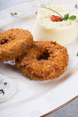 Breaded meat cutlet served with garnish