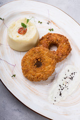 Breaded meat cutlet served with garnish