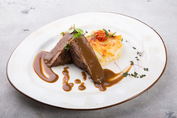 Steamed beef meat served with baked potato