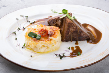 Steamed beef meat served with baked potato