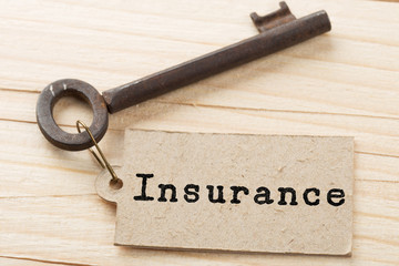 home insurance concept - old key with tag