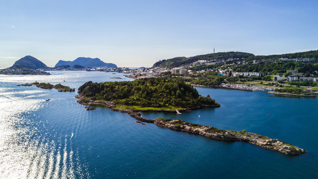 Countryside road to the sea in summer in Alnes, godoy island, Norway. Aerial shot from drone of norway landscape