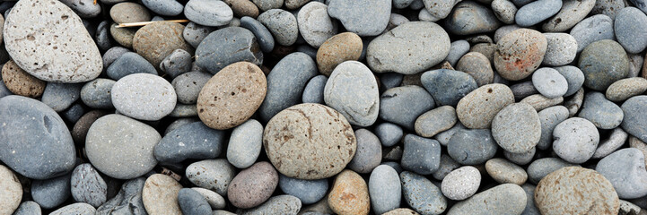 Round stones panoramic background. Gravel texture background