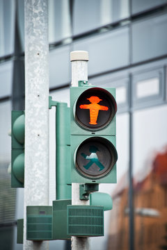 Red pedestrian traffic light with the Ampelmann of East Germany, Berlin