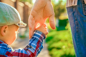 the parent holding the child's hand with a happy background