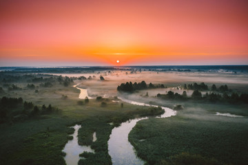 Aerial View Green Meadow And River Landscape In Misty Foggy Morning. Top View Of Beautiful European Nature From High Attitude In Summer Season. Drone View. Bird's Eye View