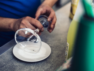 Male bartender making fancy drink