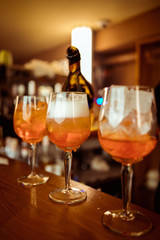 female bartender preparing aperol cocktail in a cocktail bar