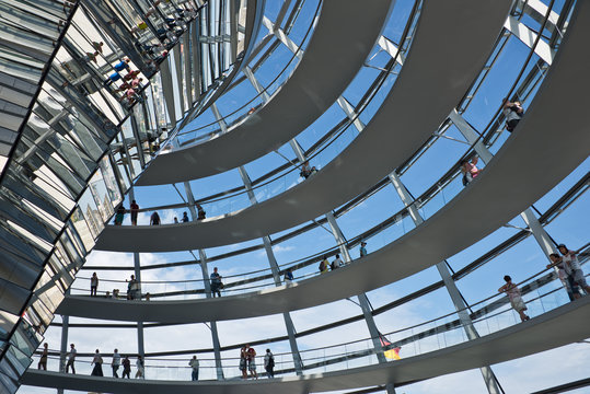 Tourists visiting the Reichstag dome, a modern glass dome constructed on top of the rebuilt Reichstag building.