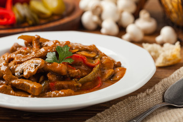 Boeuf, Stroganow, Strogonow. Classic, Russian beef stew. Served on a white plate. Front view. Natural background.