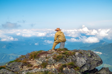 Man on top mountain looking into the distance