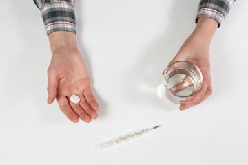 man hand with water on the background of pills