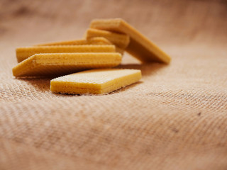 Waffles in focus on a hessian surface. Close up, Copy space.