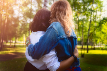 Young women are having fun on the green park in the evening.