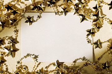 Christmas greeting paper card or Festive wish list with gold star garland and shadow on textured background