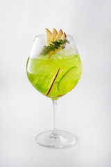 Apple Cocktail In a luxuriously shaped glass consisting of ice and sliced apples, decorated with green herbs Filmed on a white scene