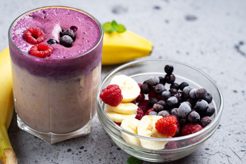 double-layered cocktail smoothie with banana, blueberries and raspberries
