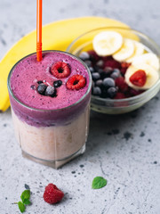 double-layered cocktail smoothie with banana, blueberries and raspberries
