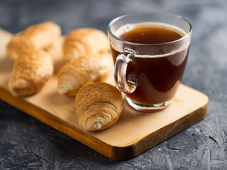 Cup of espresso and a small Breakfast croissants