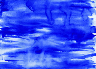 Hand-drawn watercolor illustration with transparency and liquid transitions, splashes, drops, waves on white. Blue watercolor paint on a horizontal sheet of paper. Can be used for illustration, zine