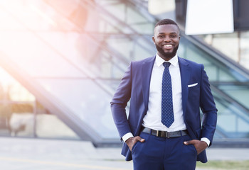 Happy Afro Businessman Smiling At Camera Standing Against Modern Building