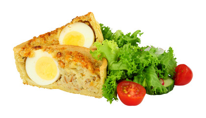 Scotch egg quiche with shortcrust pastry and whole egg encased in pork sausage meat with fresh salad isolated on a white background