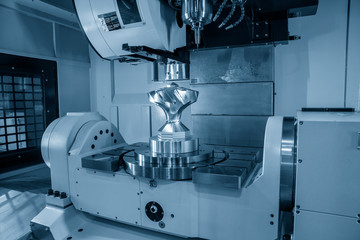 The five axis machining center cutting the mechanical parts with the solid ball endmill tools. The hi-technology mechanical parts manufacturing process by 5-axis CNC milling machine.