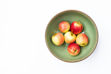 Mini fresh apple in design green ceramic bowl isolate on white background, healthy diet life style